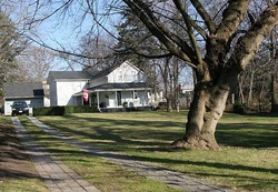 House with large green lawn in front