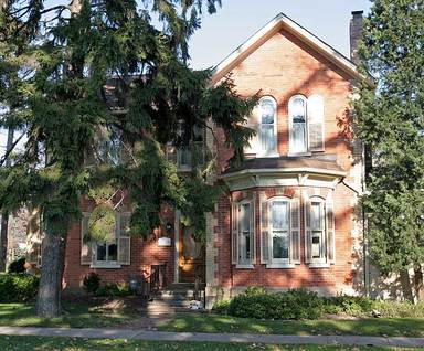 Color photo of old two story red brick house