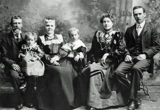 Old black and white photo of the Norton family in Victorian dress