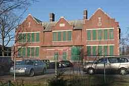 Color photo of old red brick Oakville high school