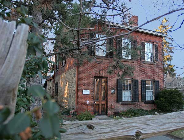 Two story red brick house early morning