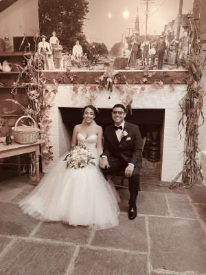 A bride and groom sitting in front of a fireplace