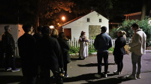 Thomas House in the evening guide surrounded by people