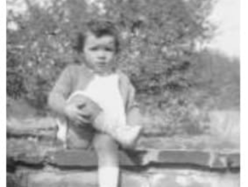 young girl sitting on stone step