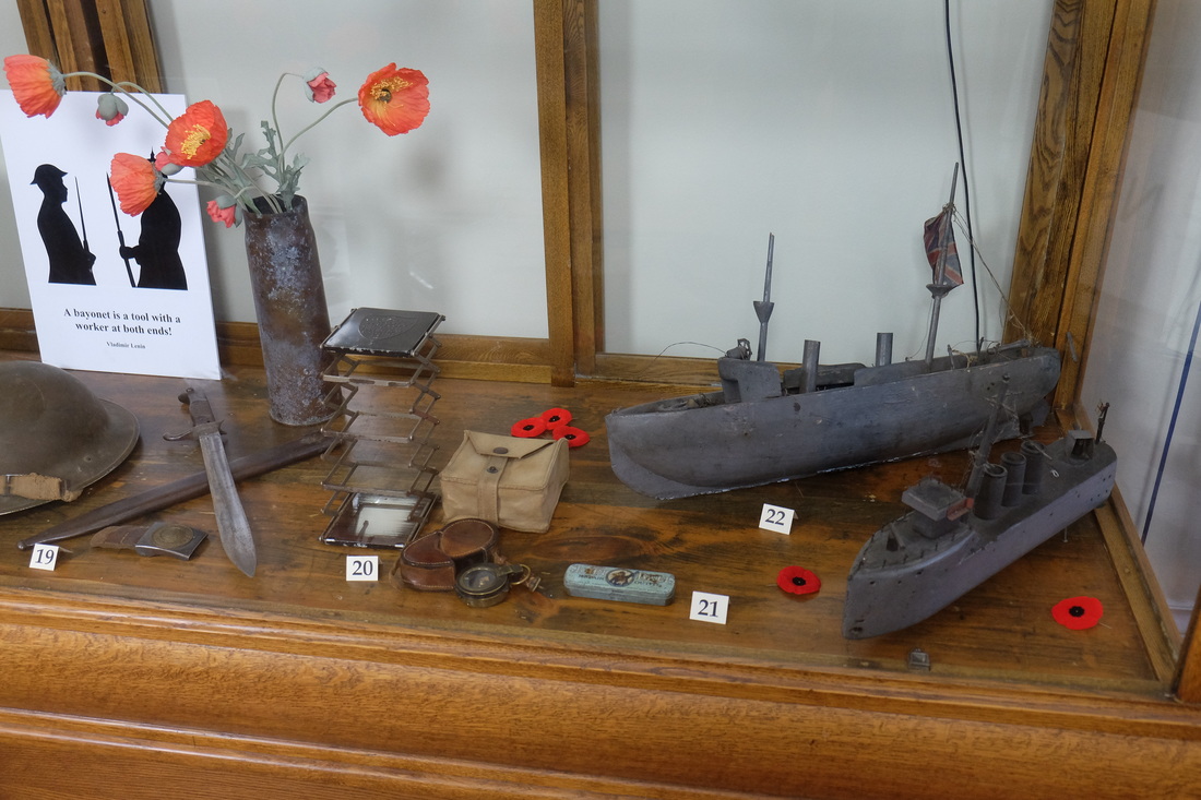 Exhibit showing small toy boats  and assorted trinkets