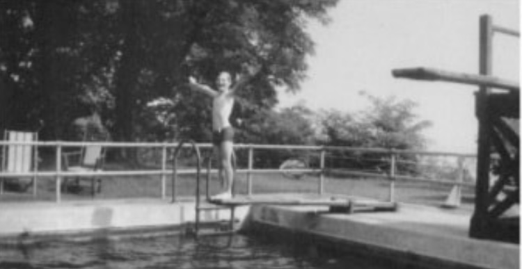 diver on diving board his hands raised up