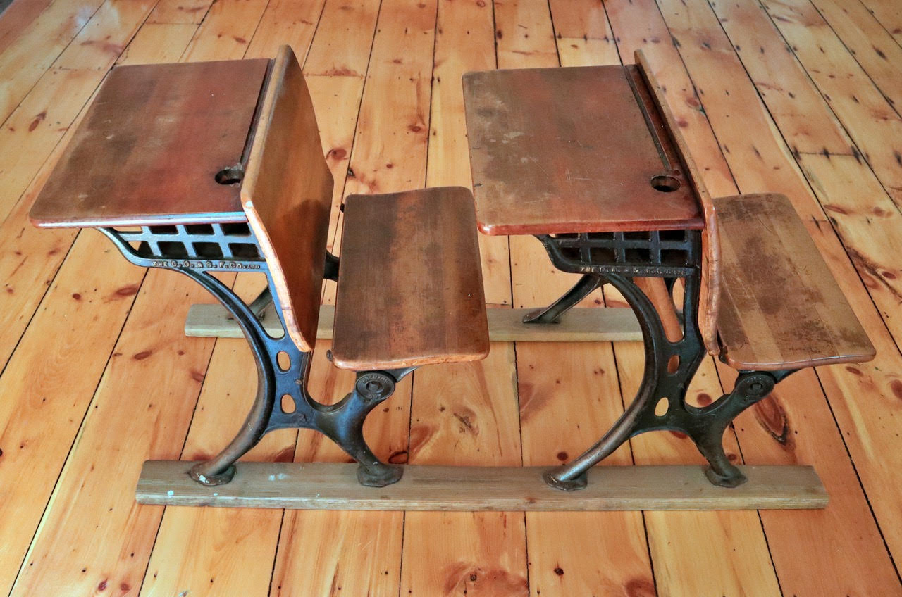 Picture of two old fashioned school desks