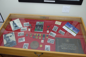 photo of display case with photos, medals and postcards