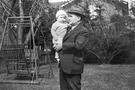 Vintage photo of Man carrying a young toddler