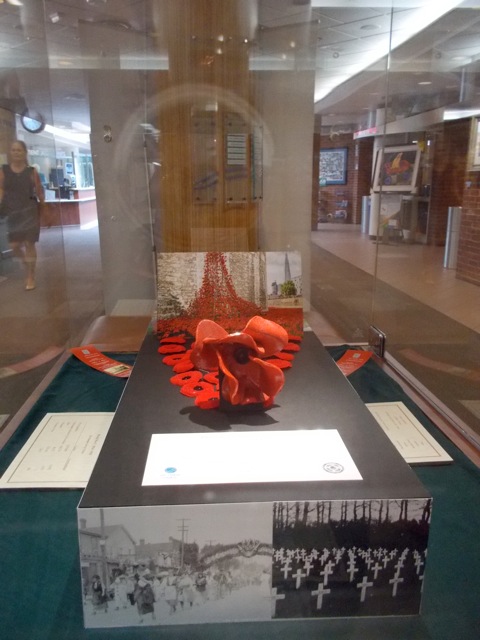 exhibit with poppies and big red bow